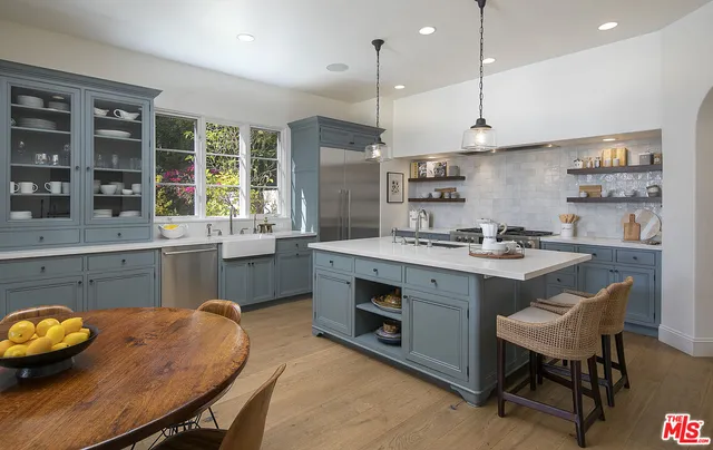 a front view of a house with garden and sitting area