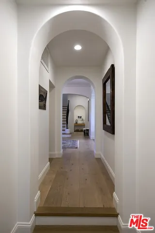 a bed room with a bed a table and a large window