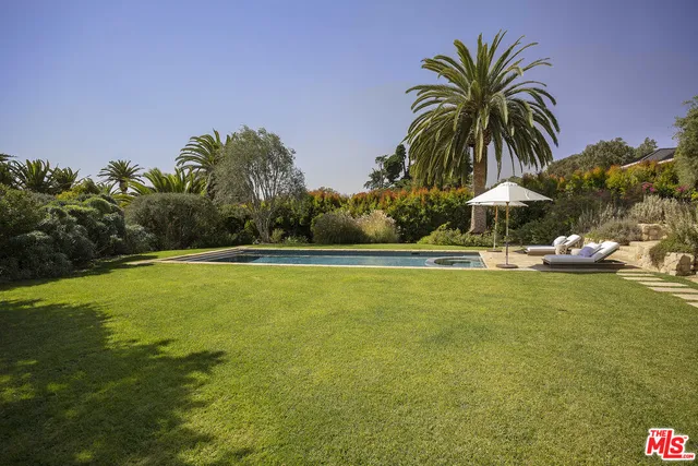 a view of a street with a bench and trees