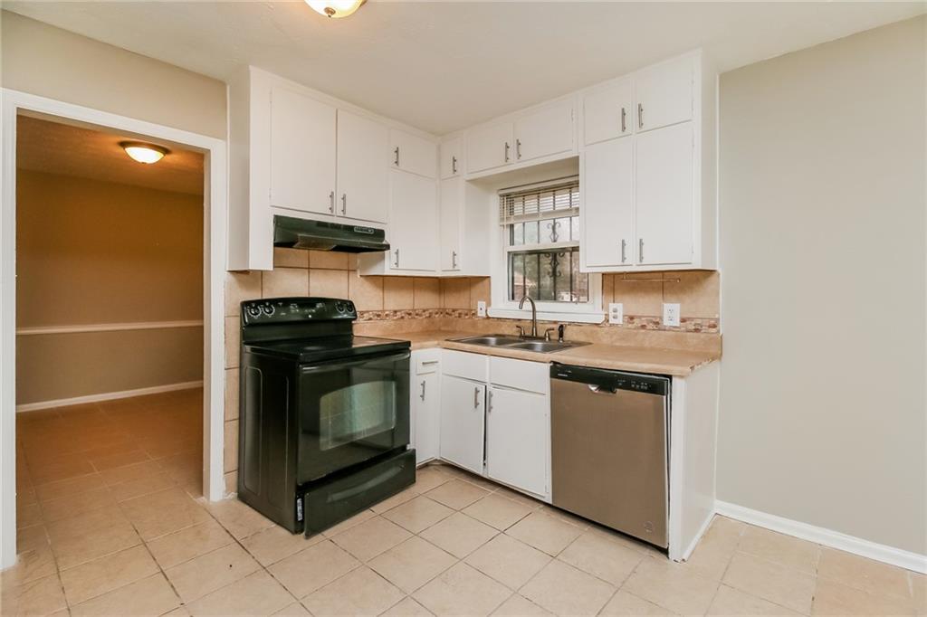 4033 Emerald N Circle Decatur, GA 30035 - Photo 8 of 25 a kitchen with stainless steel appliances granite countertop a stove a sink and a refrigerator
