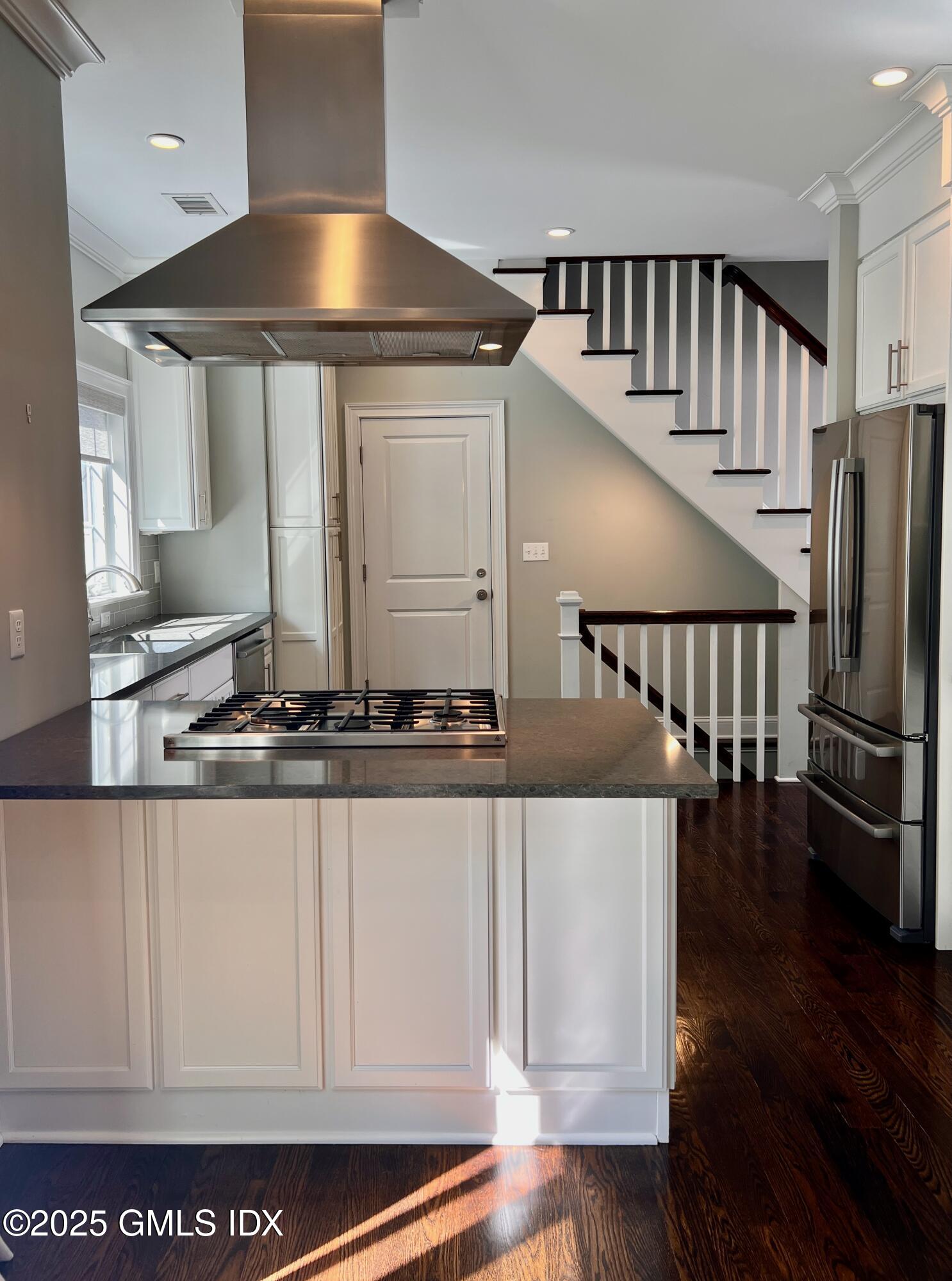 31 Moshier Street, Unit B Greenwich, CT 06831 - Photo 1 of 28 a kitchen with stainless steel appliances granite countertop a stove and a white cabinets
