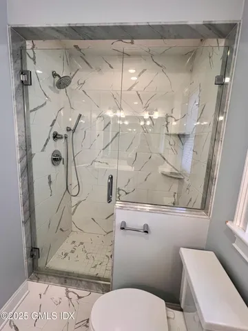 a bathroom with a toilet sink and shower