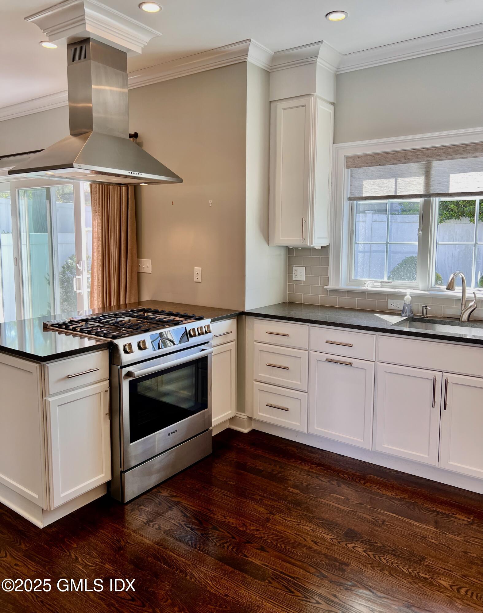 31 Moshier Street, Unit B Greenwich, CT 06831 - Photo 2 of 28 a kitchen with granite countertop a stove and a sink