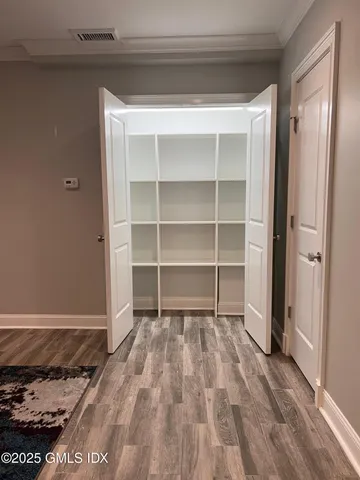 a view of an empty room and a window