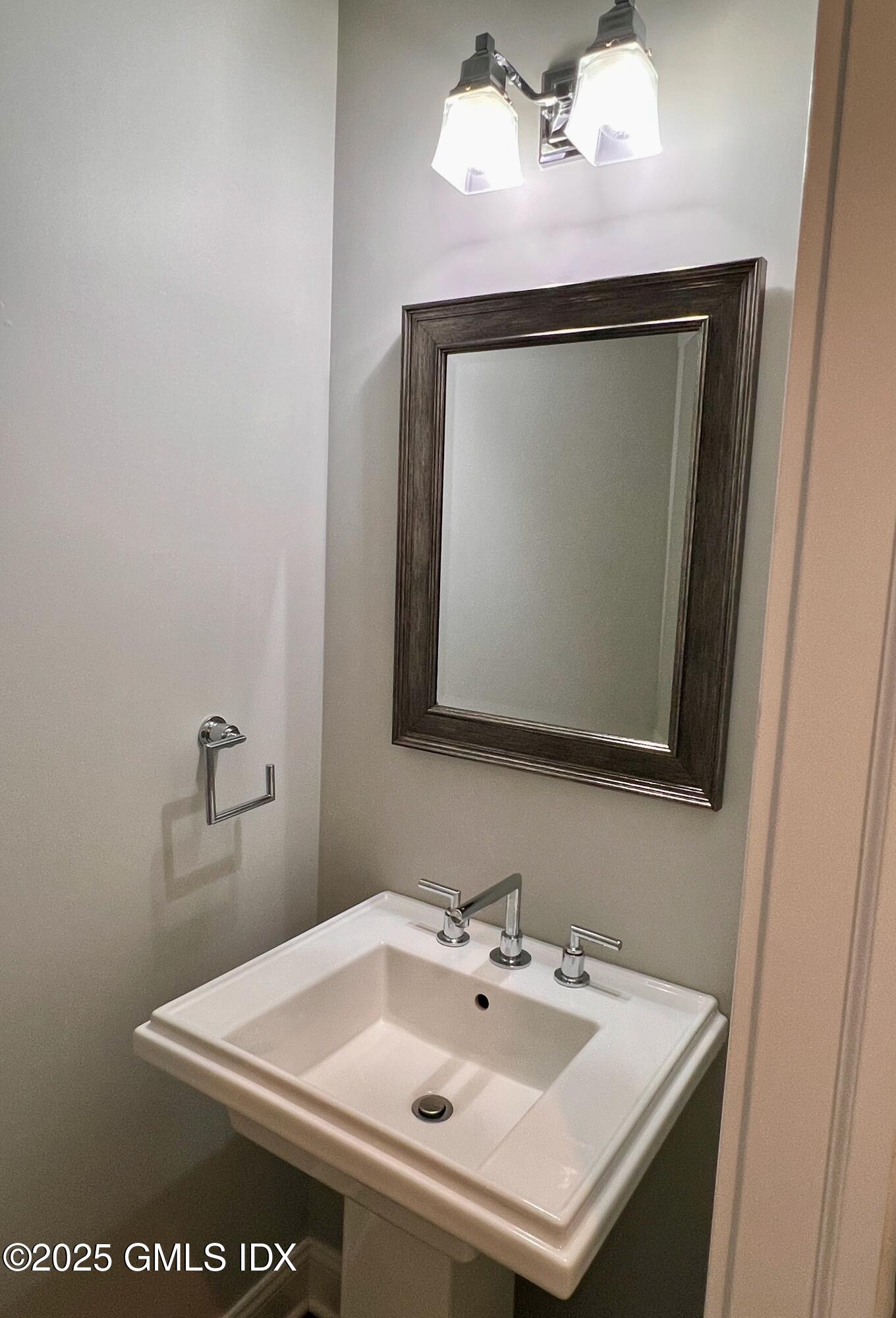 31 Moshier Street, Unit B Greenwich, CT 06831 - Photo 5 of 28 a bathroom with a sink and a mirror