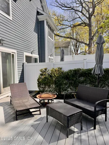 a view of a patio with couches table and chairs and potted plants