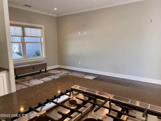 a view of a room with wooden floor