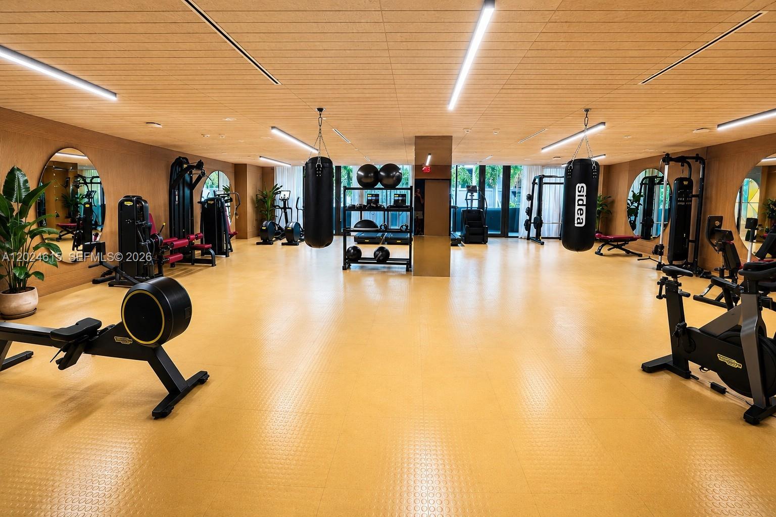 90 Northeast 32nd Street, Unit 301 Miami, FL 33127 - Photo 12 of 21 a view of a gym with pool table and chairs