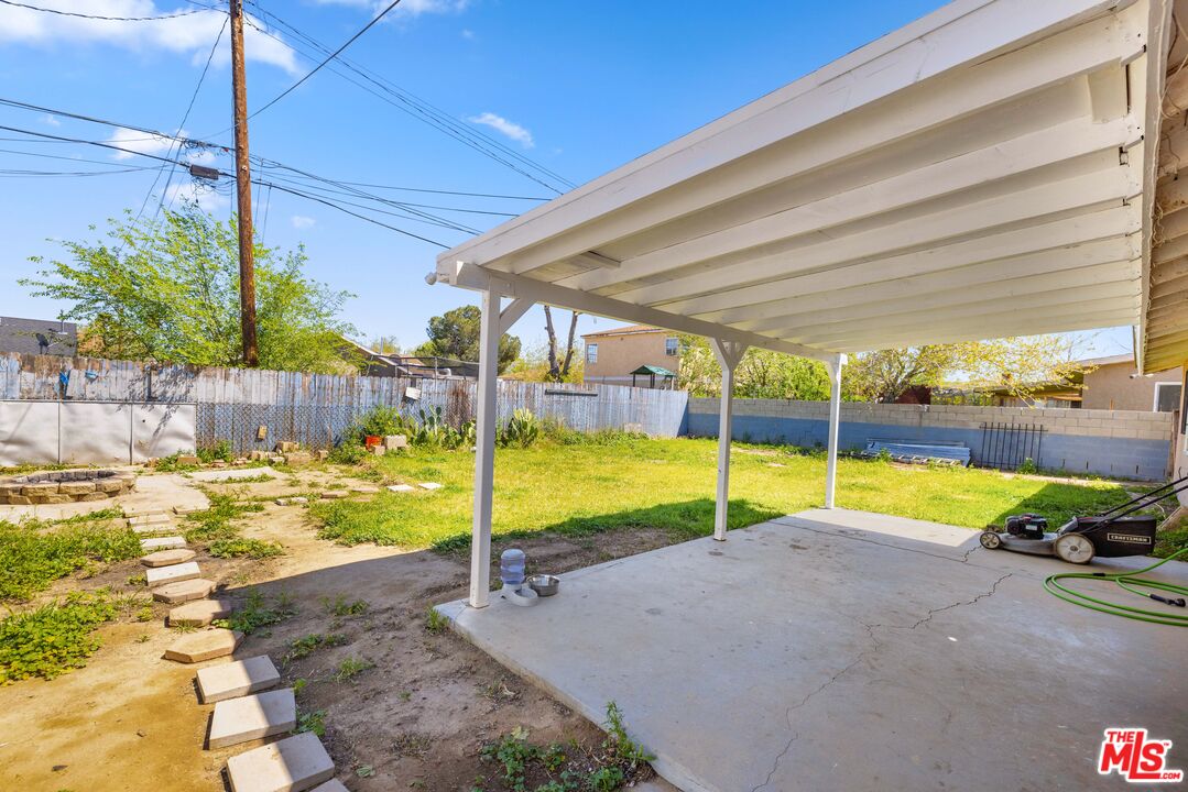 38466 Sumac Avenue Palmdale, CA 93550 - Photo 16 of 18 a view of swimming pool with lawn chairs next to yard