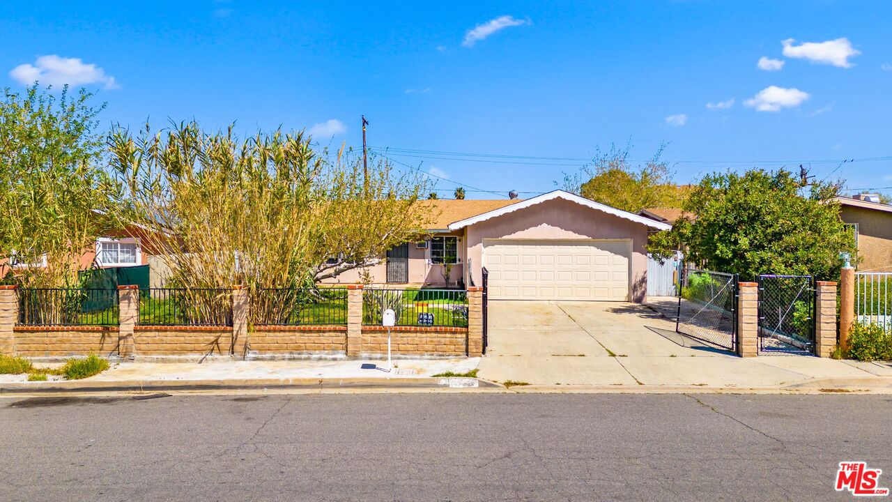 38466 Sumac Avenue Palmdale, CA 93550 - Photo 2 of 18 a view of a house with a yard and large tree