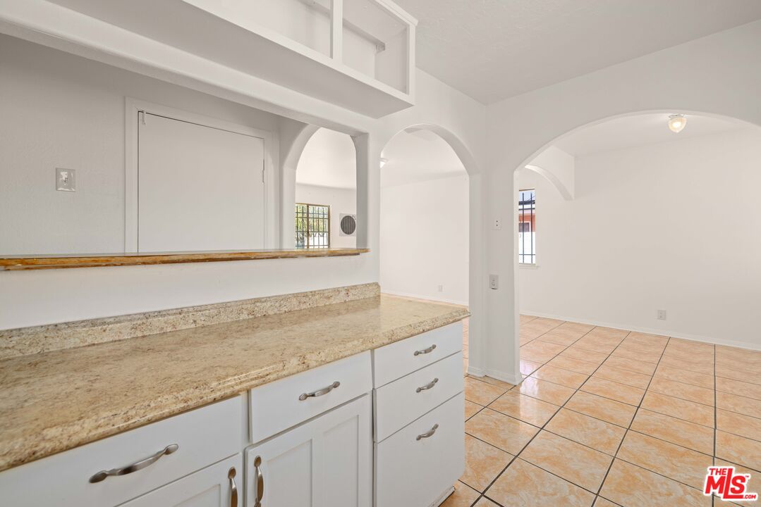 38466 Sumac Avenue Palmdale, CA 93550 - Photo 7 of 18 wooden floor with white cabinets