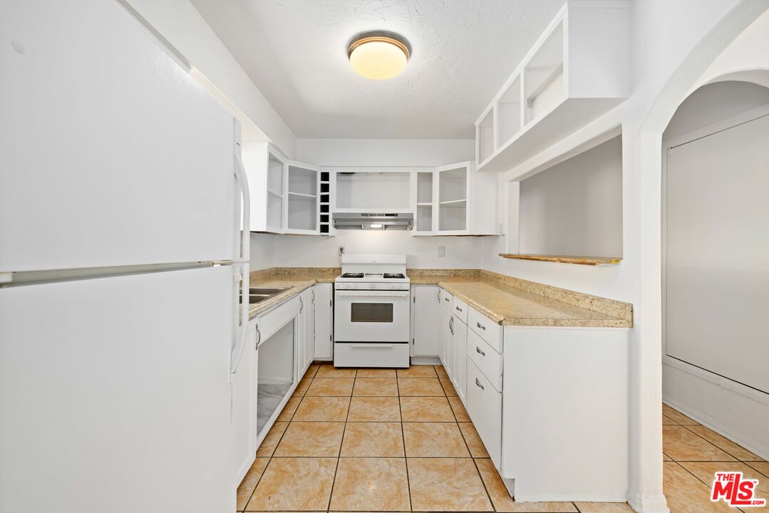 38466 Sumac Avenue Palmdale, CA 93550 - Photo 8 of 18 a kitchen with a stove top oven sink and cabinets