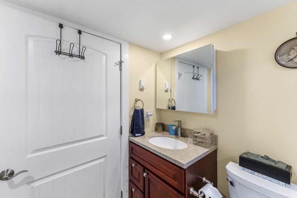 115 Kennedy Road Stoughton, MA 02072 - Photo 36 of 42 a bathroom with a sink a vanity and a mirror