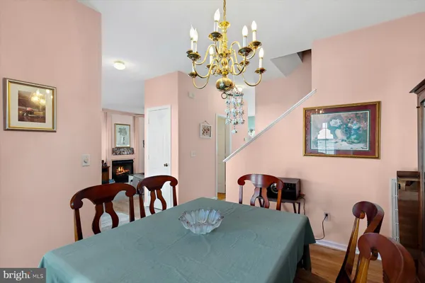 a kitchen with granite countertop a table chairs microwave and refrigerator
