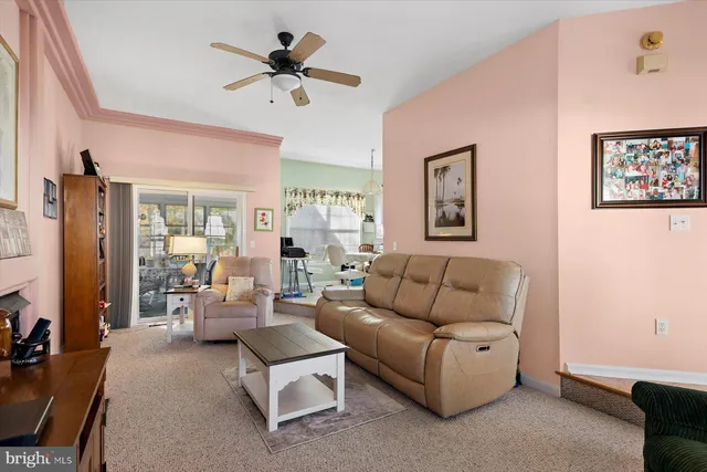 a kitchen with a sink a stove a refrigerator cabinets and a window
