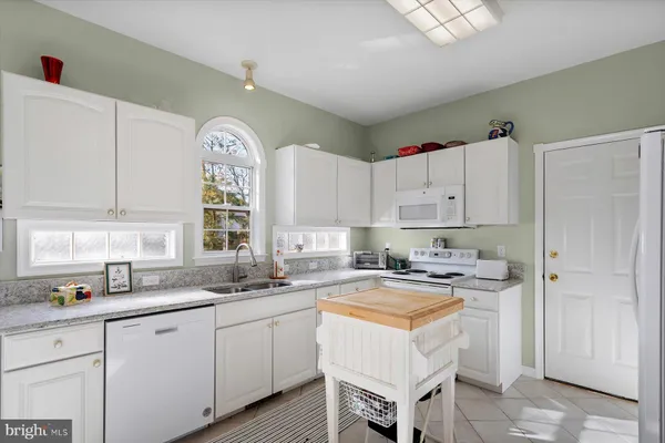 a kitchen with refrigerator and cabinets