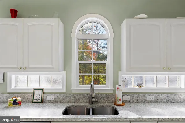 a kitchen with a sink a stove and cabinets