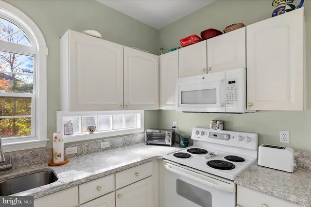 a dining room with wooden floor furniture and a chandelier