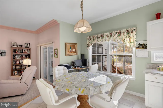 a kitchen with a refrigerator a stove and white cabinets with wooden floor