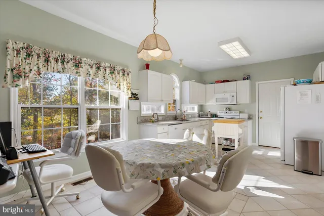 a kitchen with refrigerator and cabinets