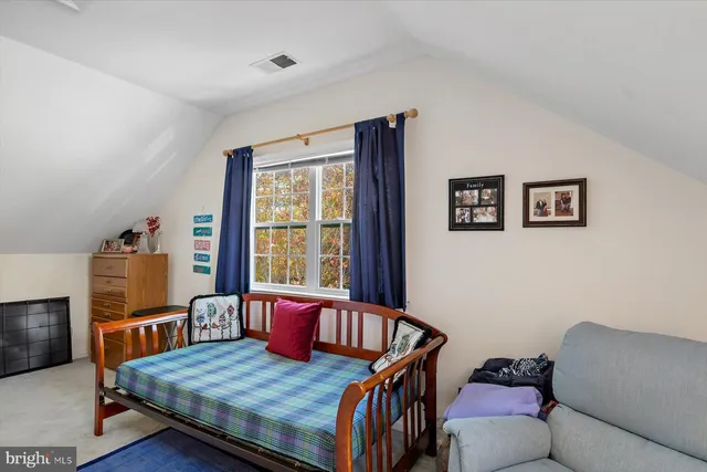 a view of a hallway with furniture and a window
