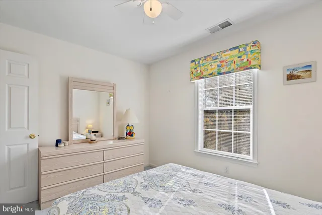 a bedroom with a bed dresser and a window