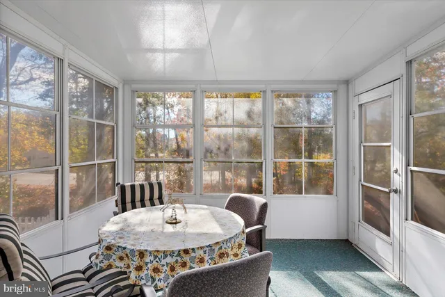 a view of a chair and table in backyard of the house
