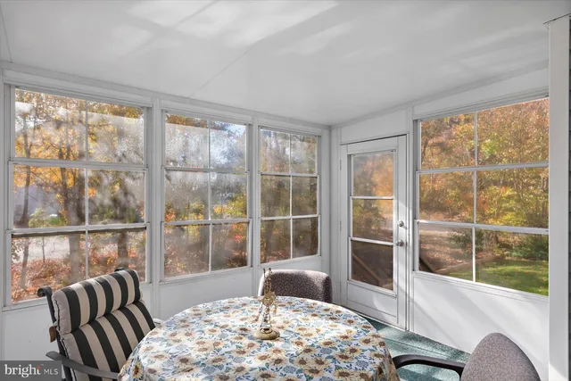 a view of a house with backyard porch and sitting area