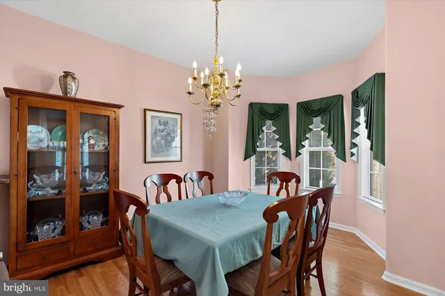 a view of a dining room with furniture and chandelier