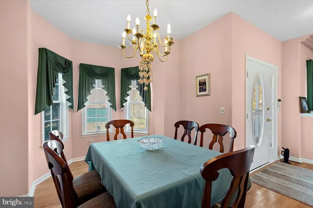 a view of a dining room with furniture and chandelier