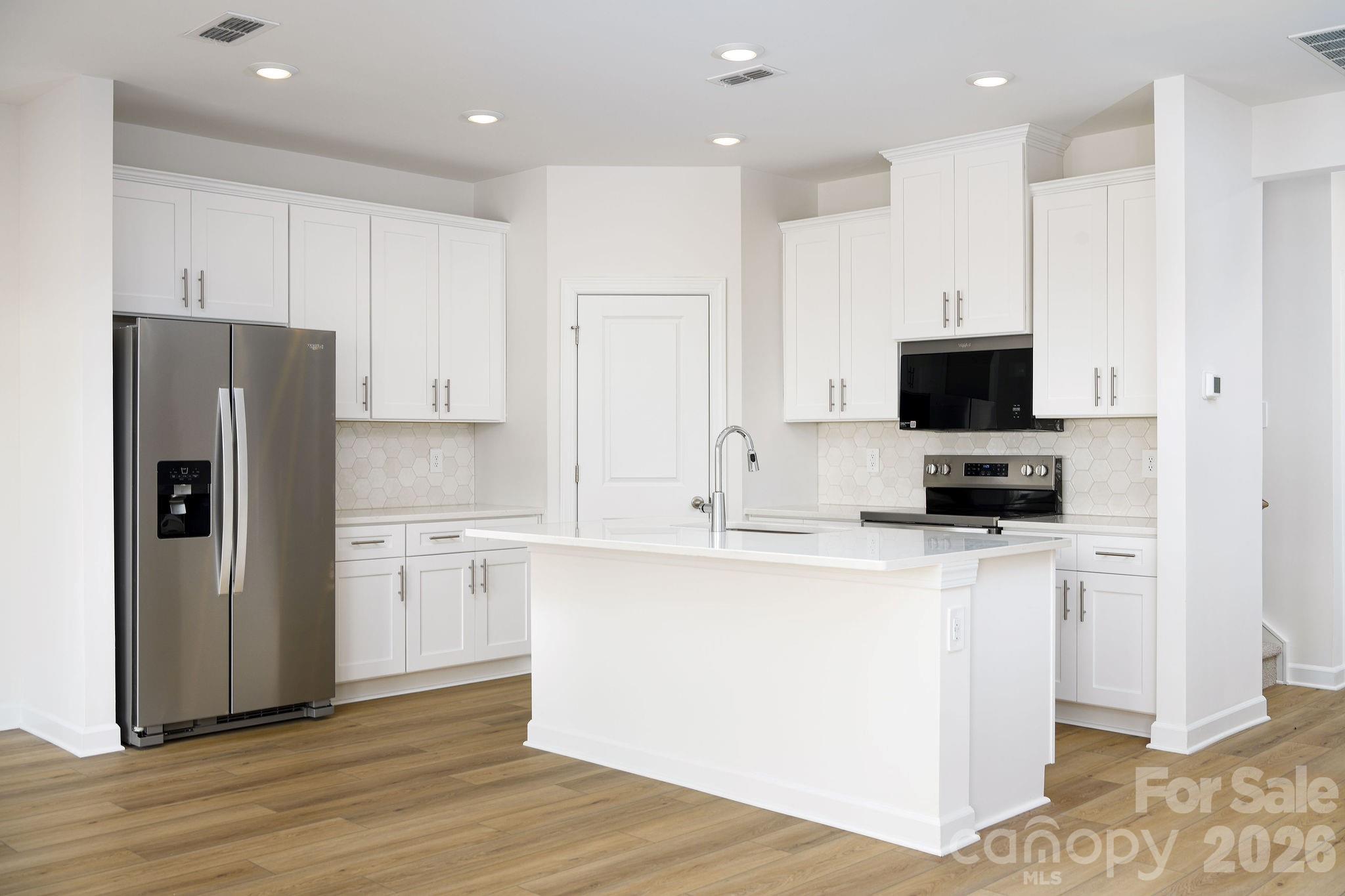 179 Murphy Mdw Road Mocksville, NC 27028 - Photo 14 of 43 a kitchen with stainless steel appliances a refrigerator stove microwave and cabinets