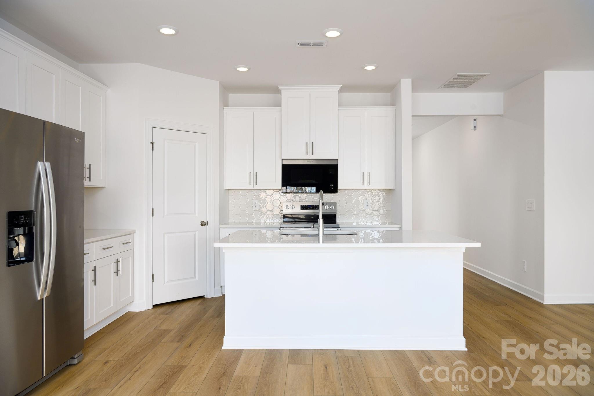 179 Murphy Mdw Road Mocksville, NC 27028 - Photo 15 of 43 a kitchen with stainless steel appliances a refrigerator a stove top oven a sink and a refrigerator