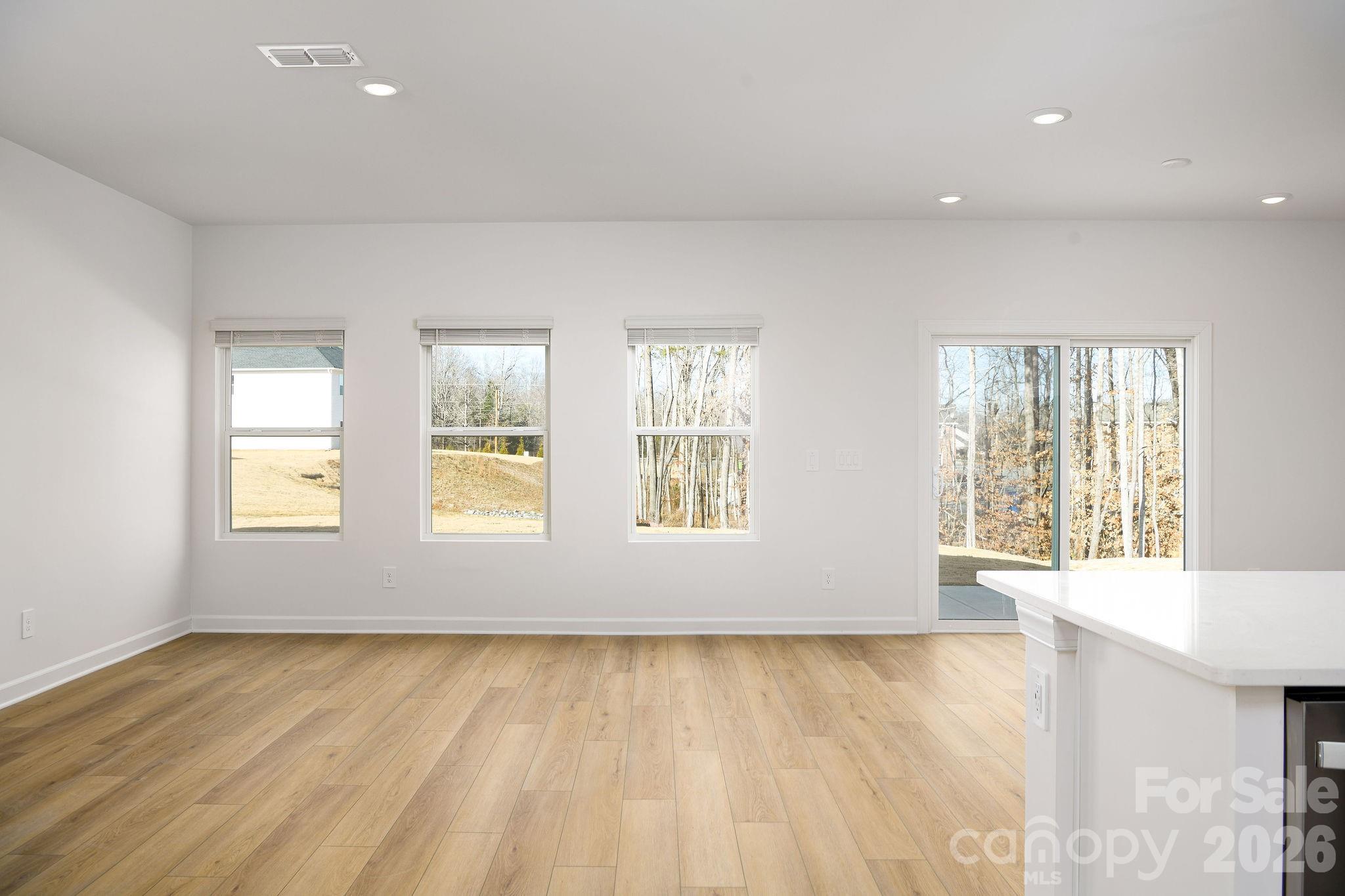 179 Murphy Mdw Road Mocksville, NC 27028 - Photo 18 of 43 a view of an empty room with wooden floor and a window