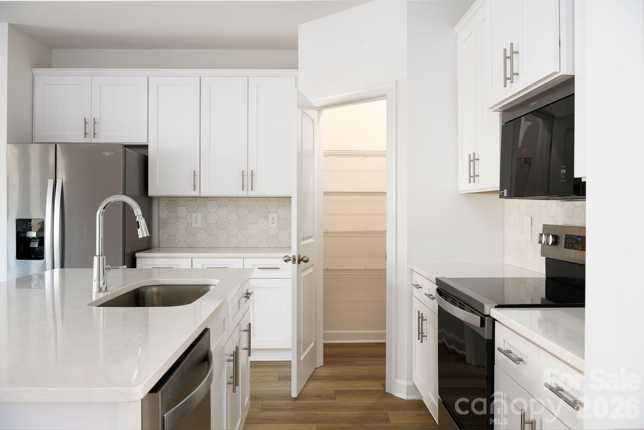 179 Murphy Mdw Road Mocksville, NC 27028 - Photo 19 of 43 a kitchen with a sink a stove and refrigerator