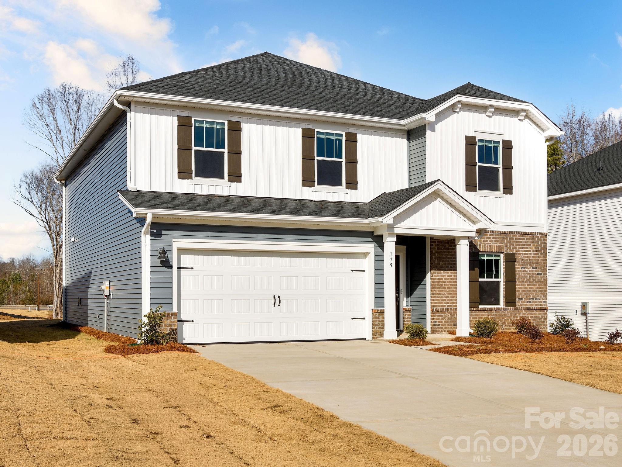 179 Murphy Mdw Road Mocksville, NC 27028 - Photo 2 of 43 a front view of a house with a yard and garage