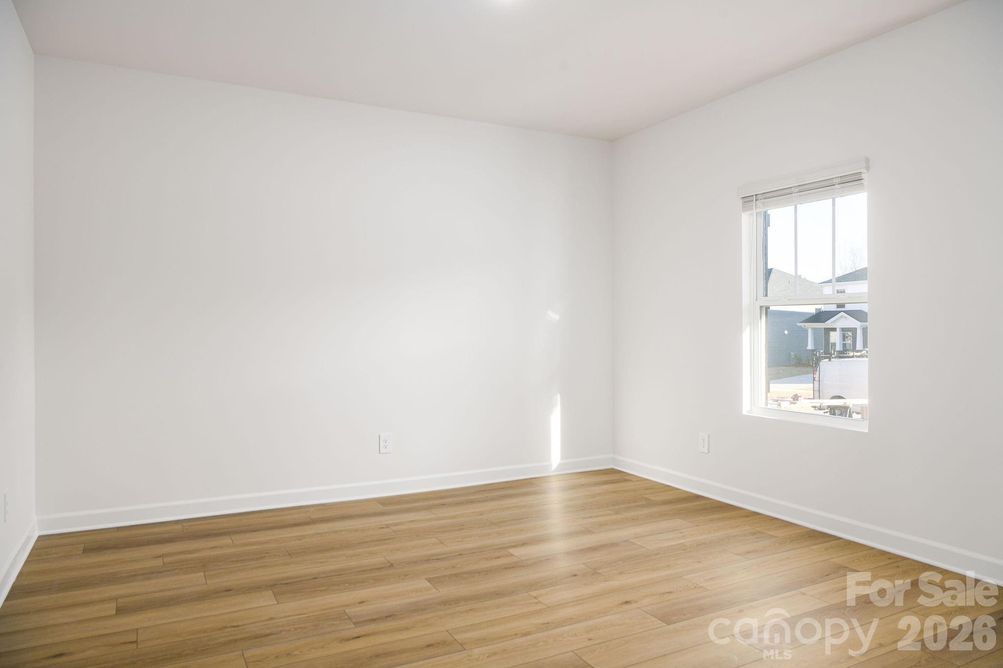 179 Murphy Mdw Road Mocksville, NC 27028 - Photo 39 of 43 an empty room with wooden floor and windows