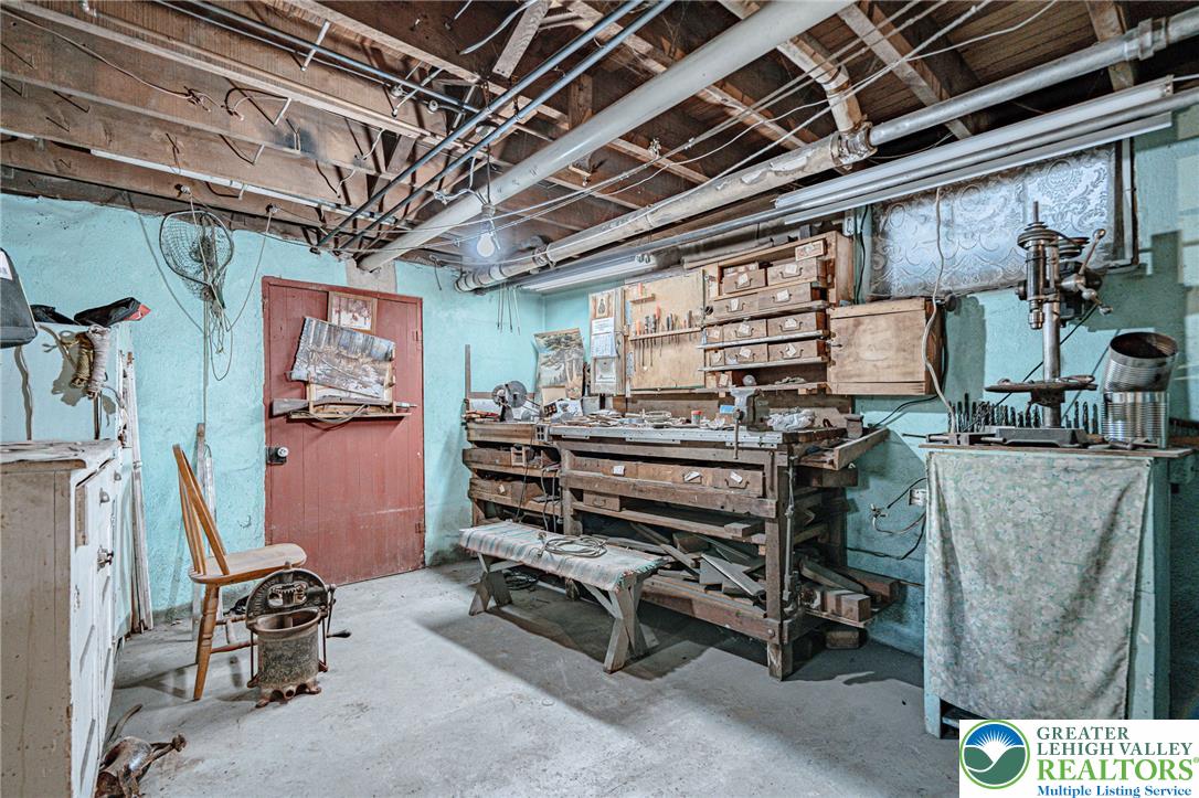 159 West Ridge Street Nesquehoning, PA 18240 - Photo 32 of 55 A well-lit, utilitarian basement offers ample space for a dedicated workshop.