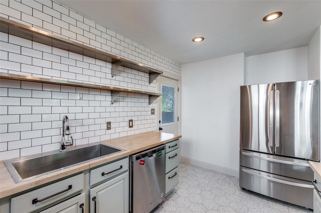 2012 Payne Avenue, Unit A Austin, TX 78757 - Photo 15 of 33 Kitchen featuring a stainless steel French door refrigerator, subway tile backsplash, open shelving, dishwasher, and a deep basin sink