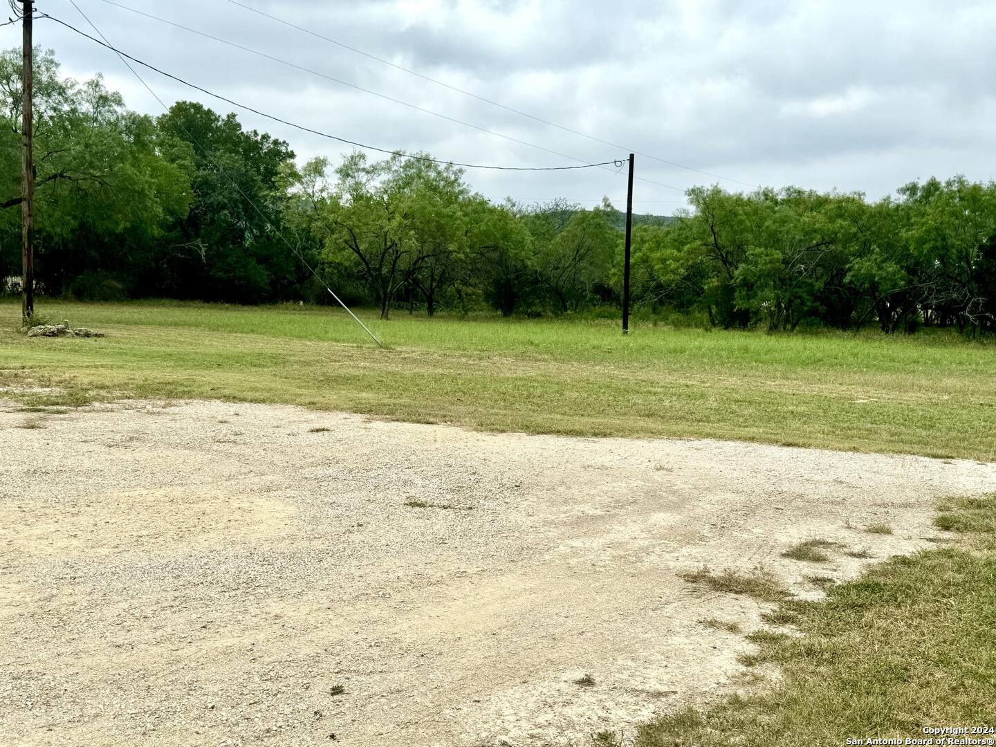 1189 North A Cr Concan, TX 78838 - Photo 13 of 68 a view of a garden with a building in the background