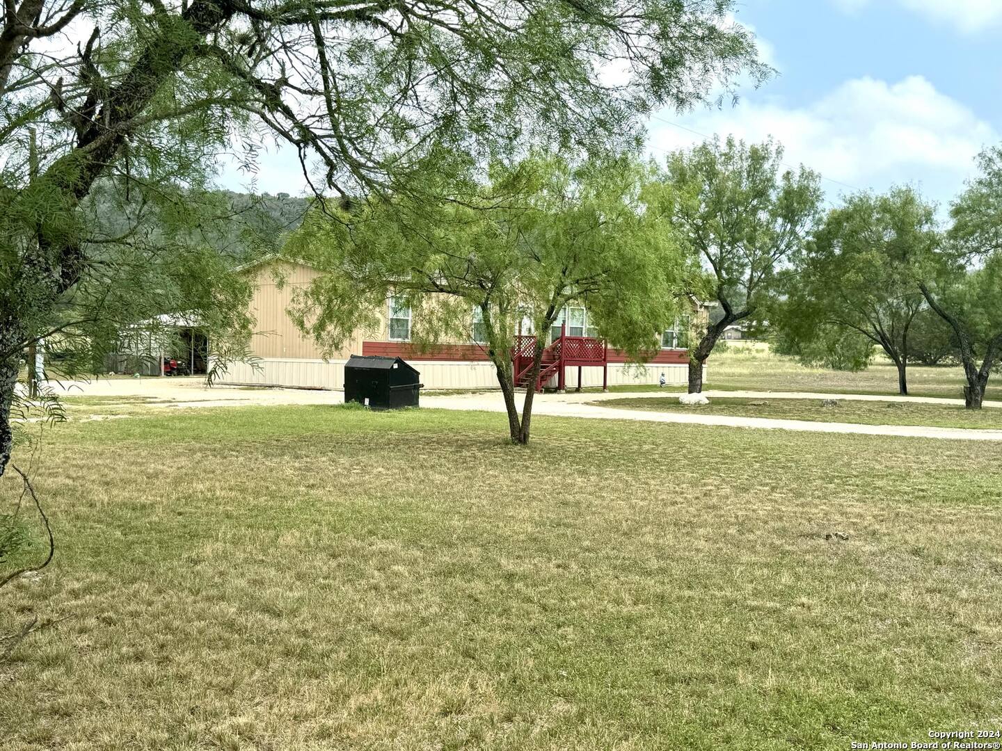 1189 North A Cr Concan, TX 78838 - Photo 16 of 68 a large room with trees in the background