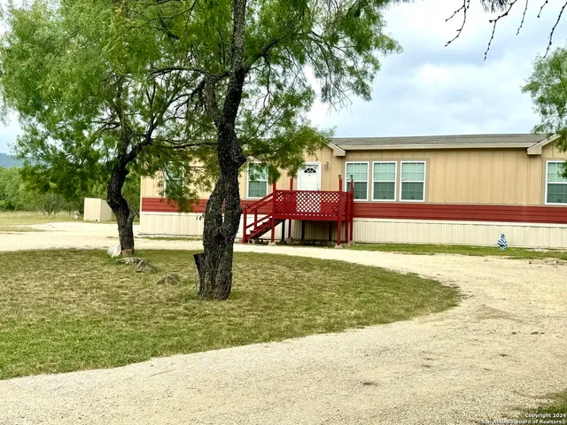 an aerial view of a house with yard