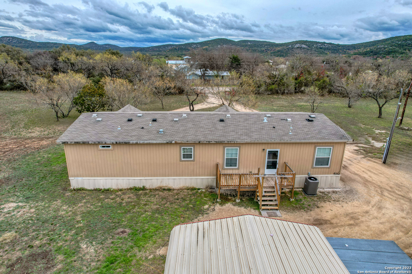 1189 North A Cr Concan, TX 78838 - Photo 23 of 68 an aerial view of a house with a yard