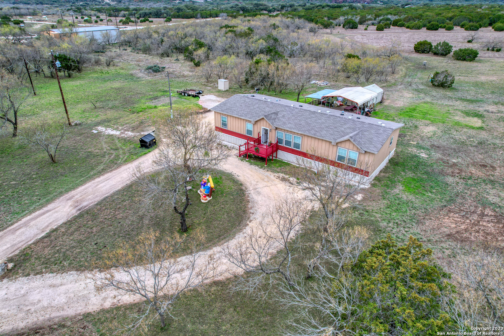 1189 North A Cr Concan, TX 78838 - Photo 24 of 68 an aerial view of a house with a garden