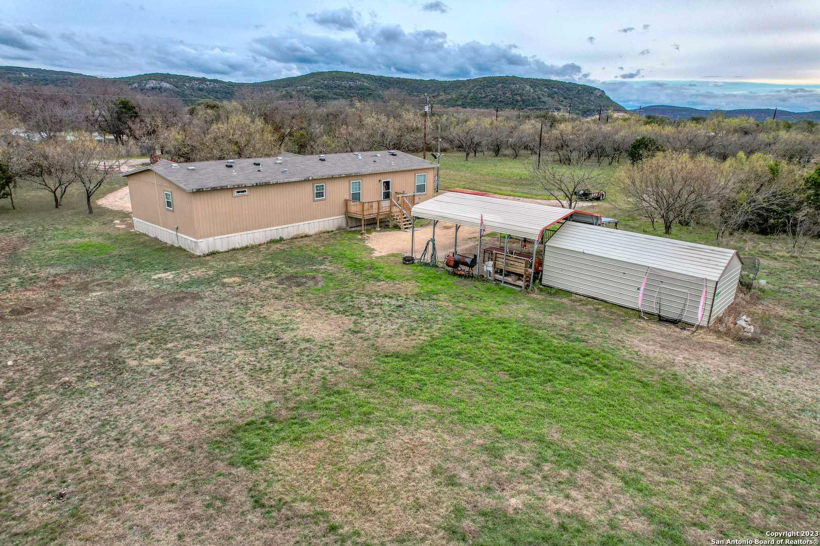 1189 North A Cr Concan, TX 78838 - Photo 26 of 68 an aerial view of a house with pool and a yard