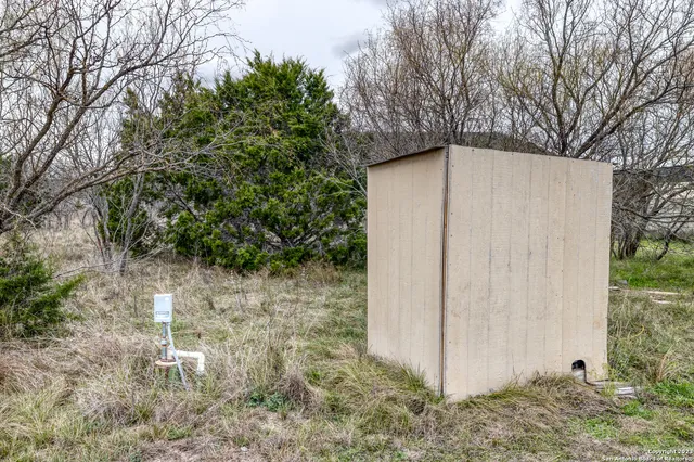 a bedroom with a bed dresser and a large window