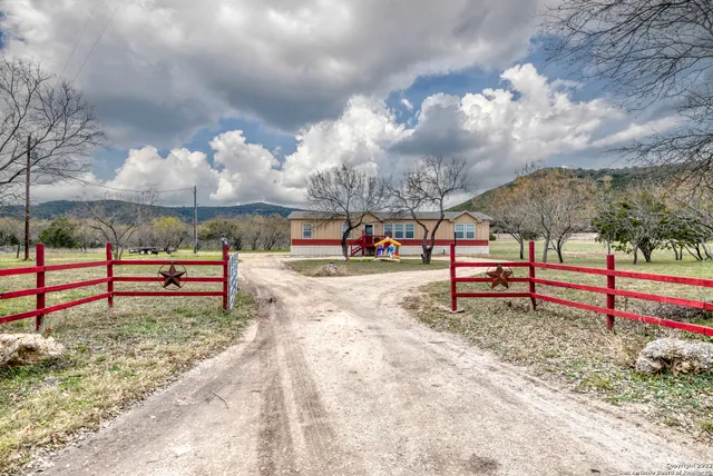 a dining room with furniture a chandelier and wooden floor