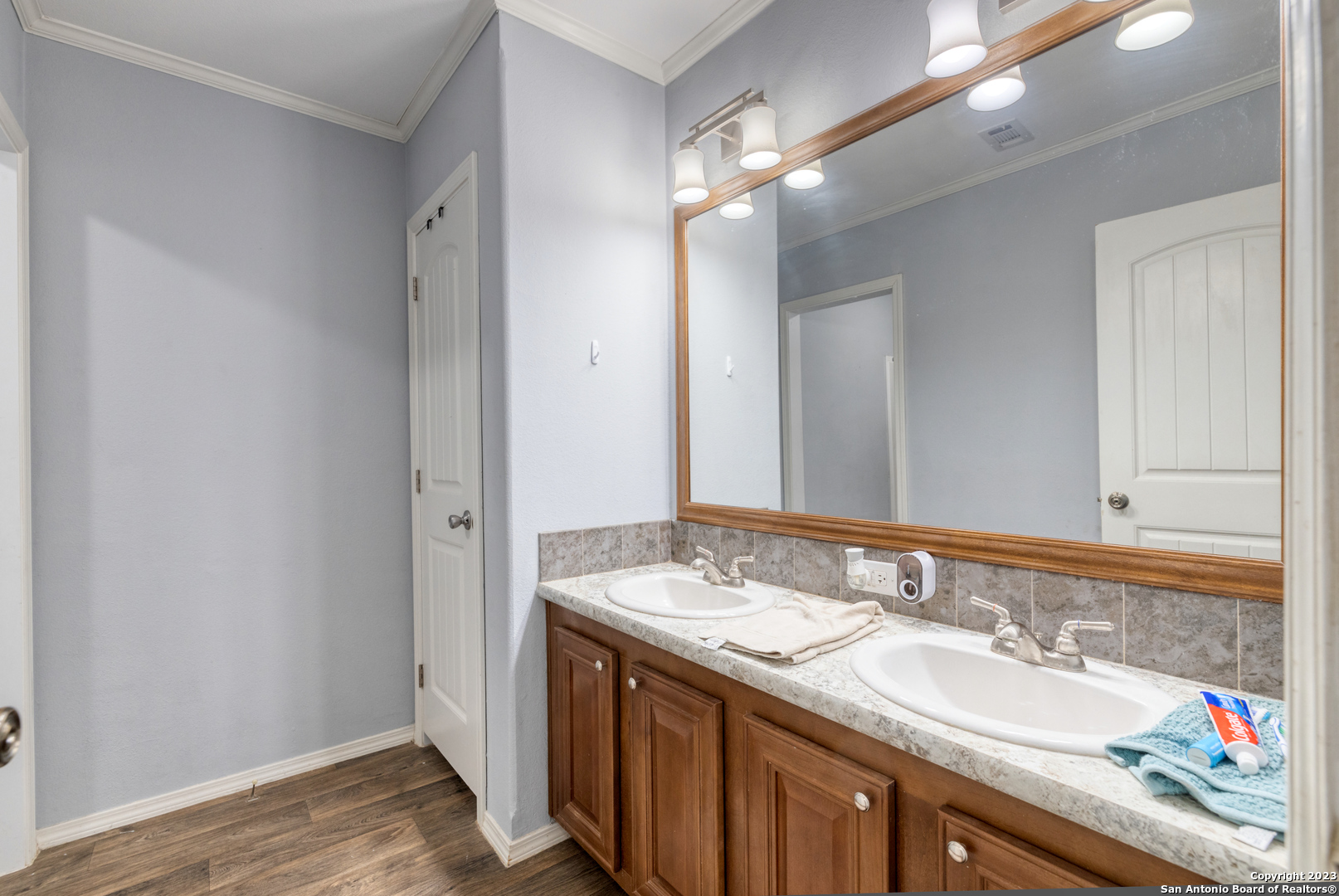 1189 North A Cr Concan, TX 78838 - Photo 56 of 68 a bathroom with a granite countertop double vanity and a mirror