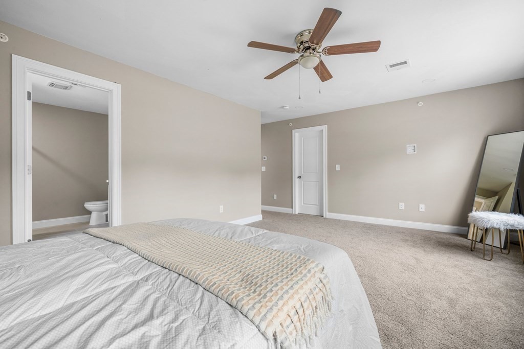 184 Berlin Road Bolton, MA 01740 - Photo 15 of 33 a spacious bedroom with a bed and a ceiling fan
