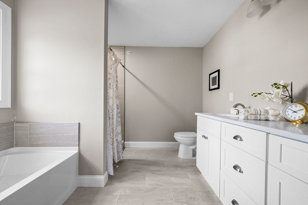184 Berlin Road Bolton, MA 01740 - Photo 16 of 33 a bath room with a toilet a sink and a bathtub