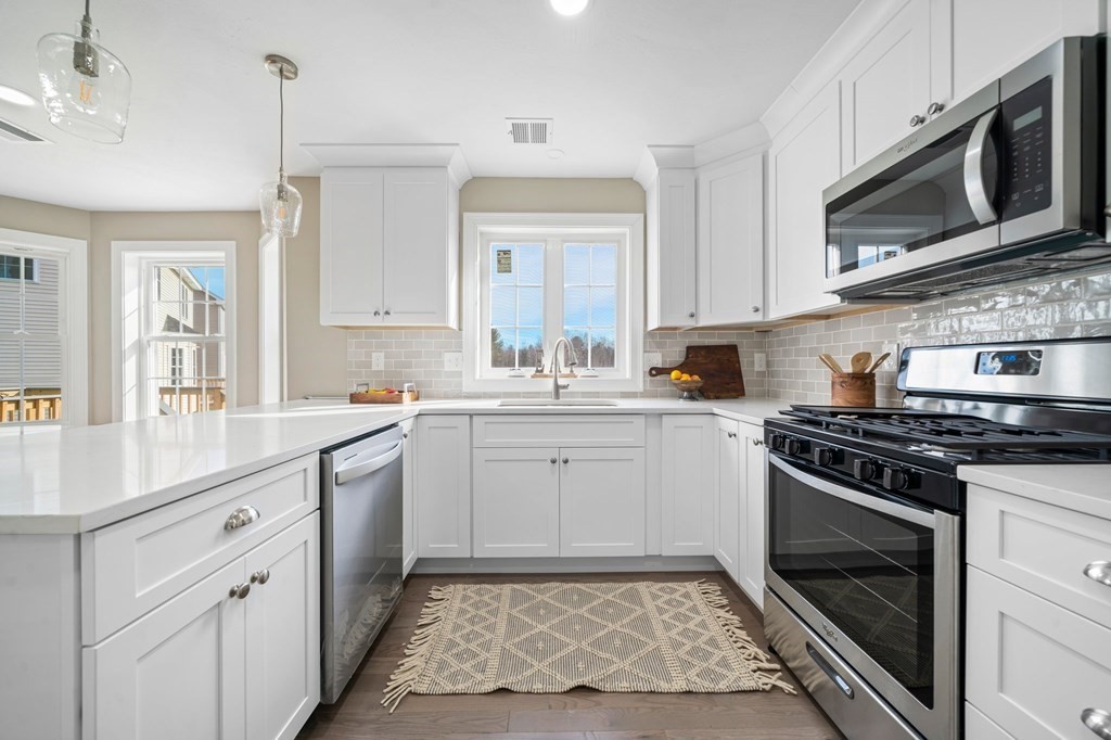 184 Berlin Road Bolton, MA 01740 - Photo 2 of 33 a kitchen with a stove microwave and sink